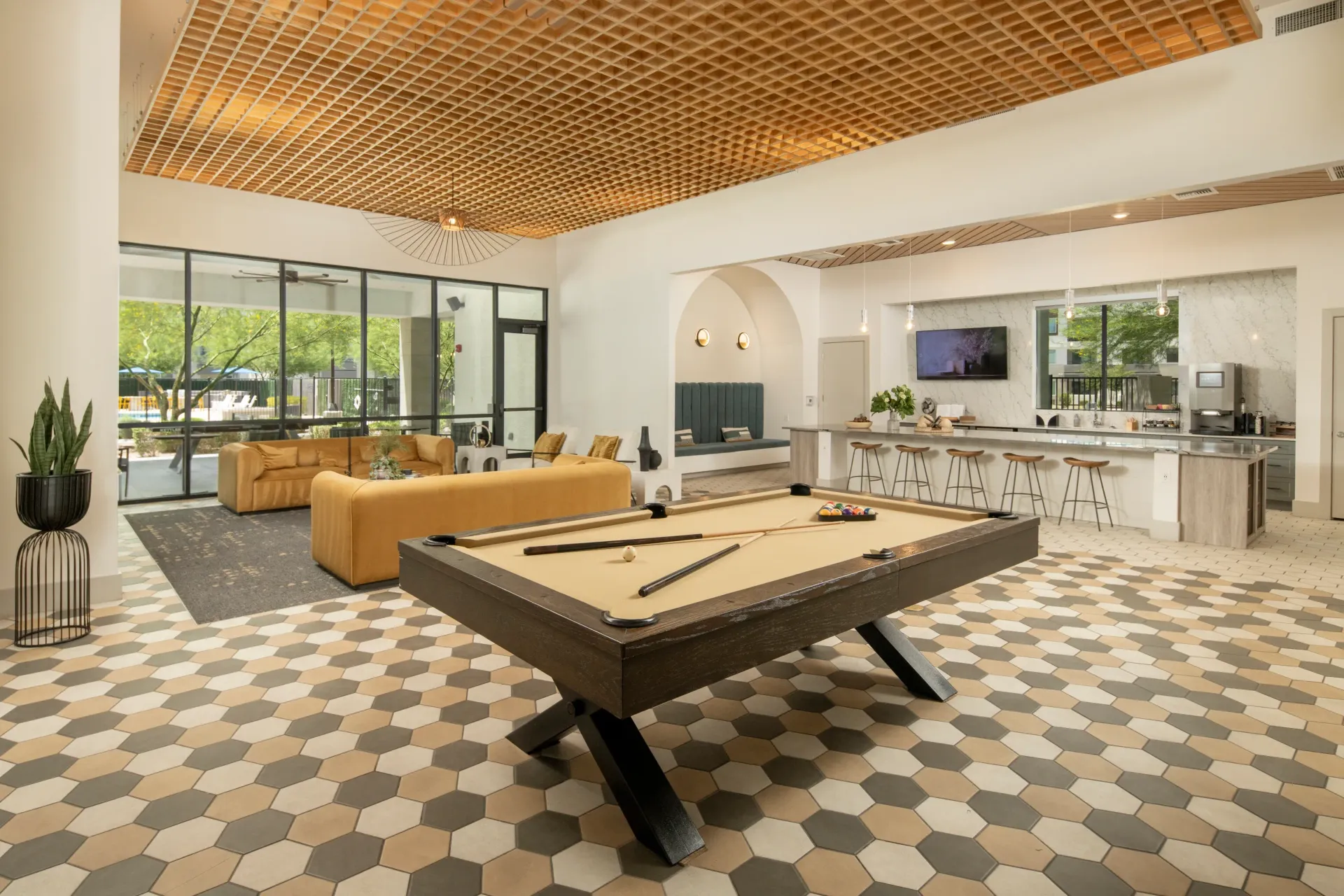 Billiard table in the resident lounge with seating and a bar area at Lumina Mountain Vista in Mesa, AZ.