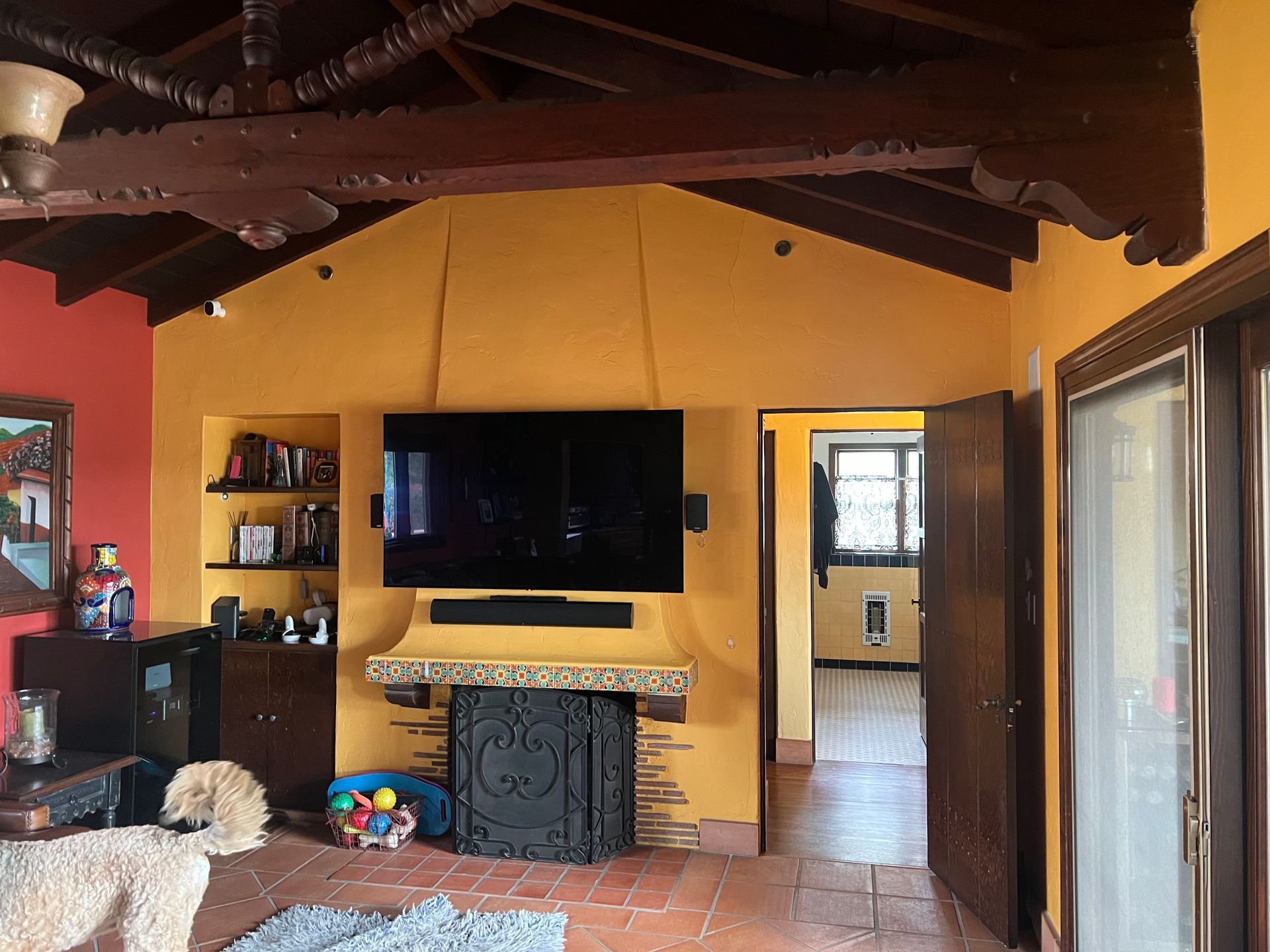A living room with a fireplace and a flat screen tv