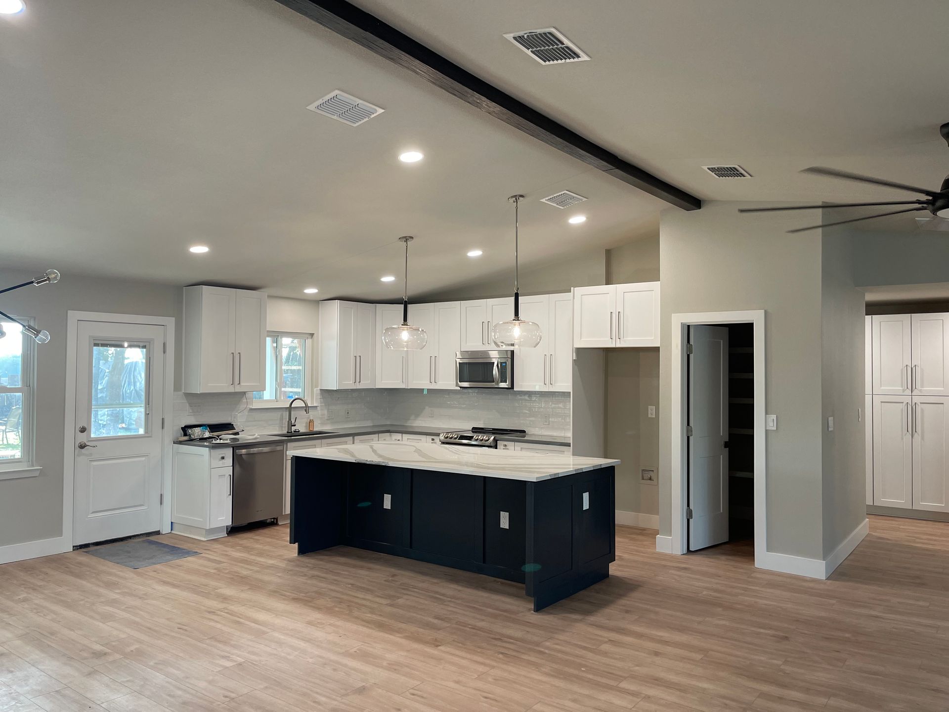 A kitchen with wooden cabinets and stainless steel appliances