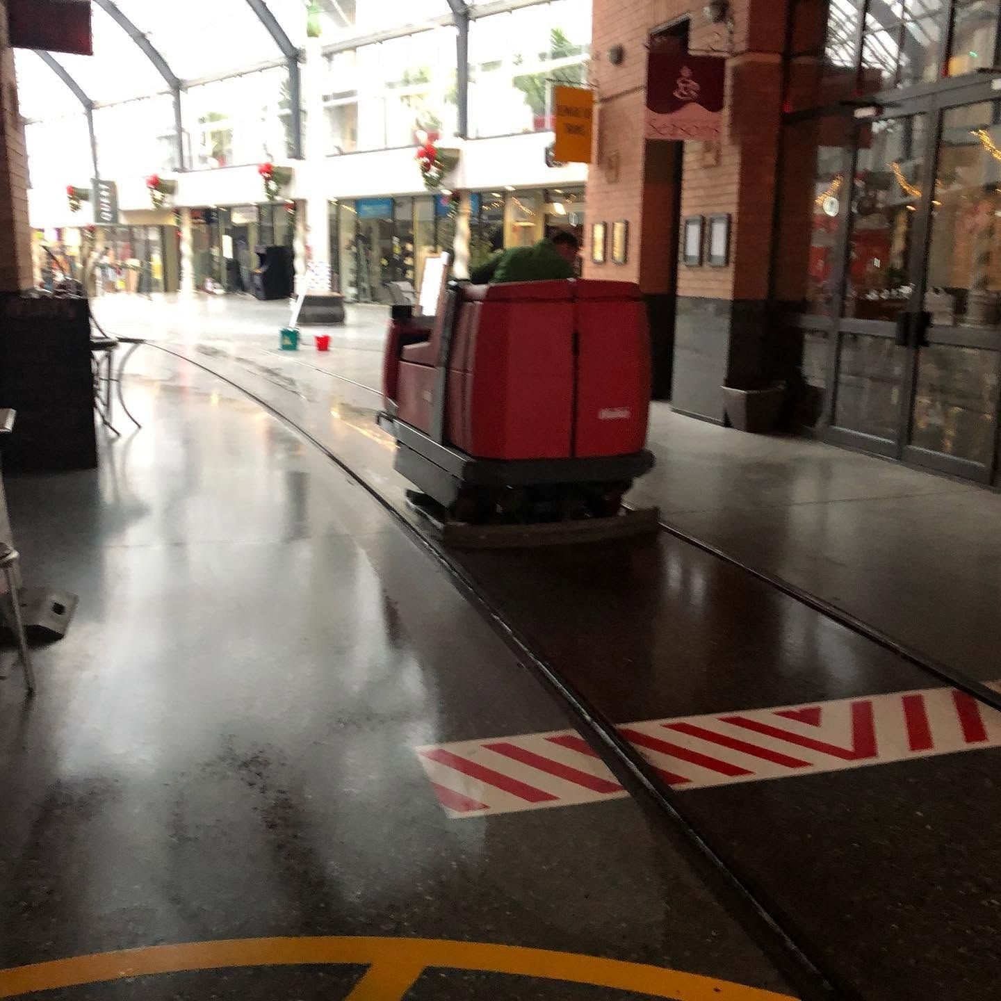 Ride-on floor cleaning in a large industrial space