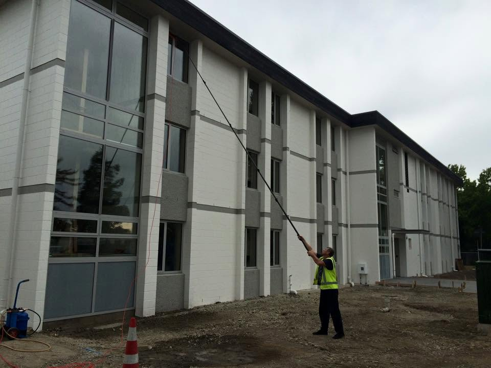 Professional exterior window cleaning using a long-reach pole