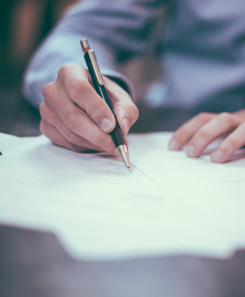 Person writing with a pen