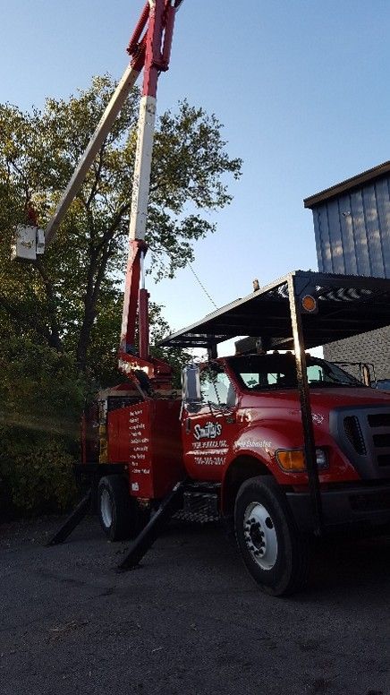 A red truck with a crane on the back A red truck with a crane on the back