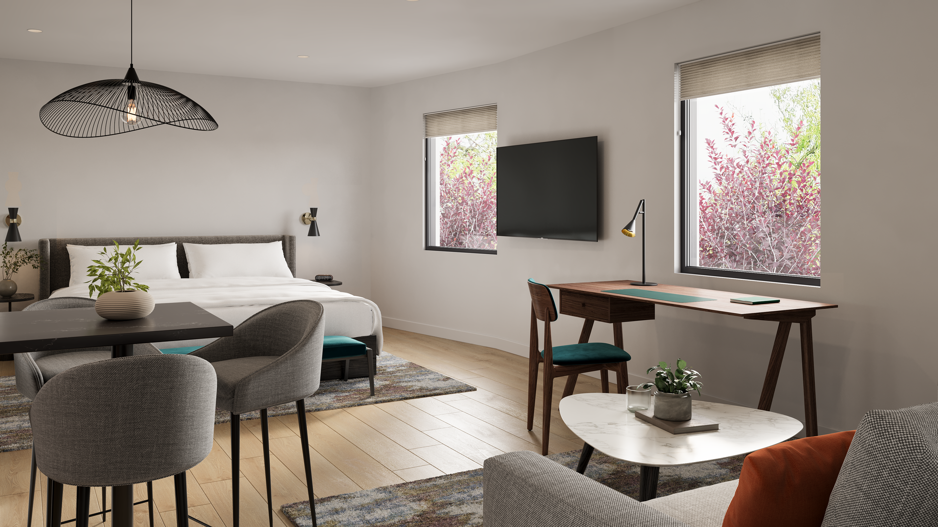A modern studio apartment with a bed, desk, dining area, and large windows.