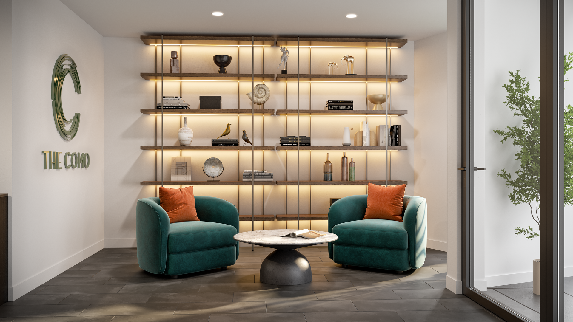 Cozy lounge area with teal armchairs, coffee table, and lit shelving displaying decor.