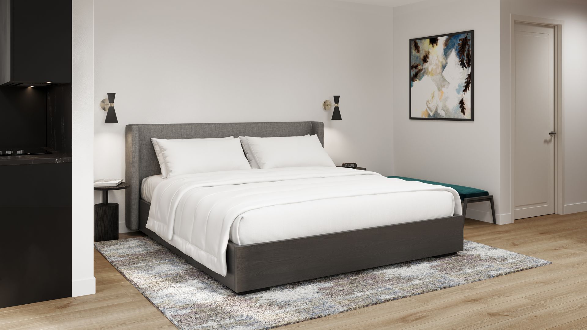 Modern bedroom with gray bed, white bedding, rug, art, and black side table.