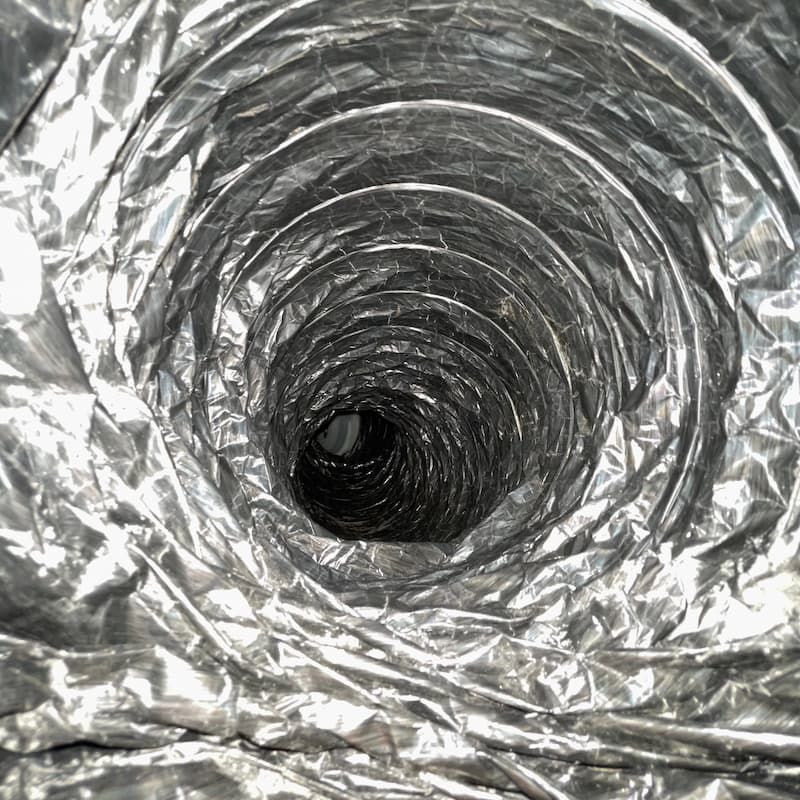 Inside view of a metallic, flexible ductwork with a spiraling design.