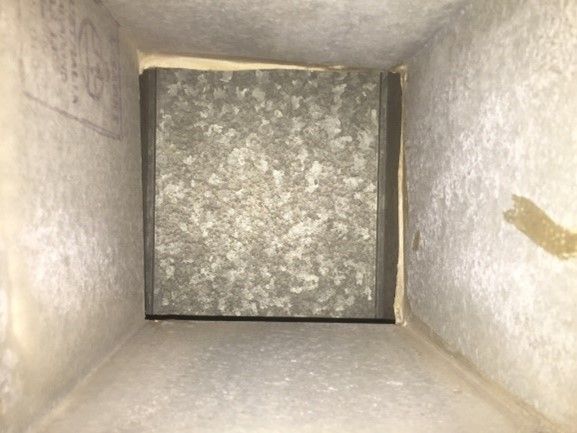 Inside view of a rectangular air duct with a galvanized metal interior.