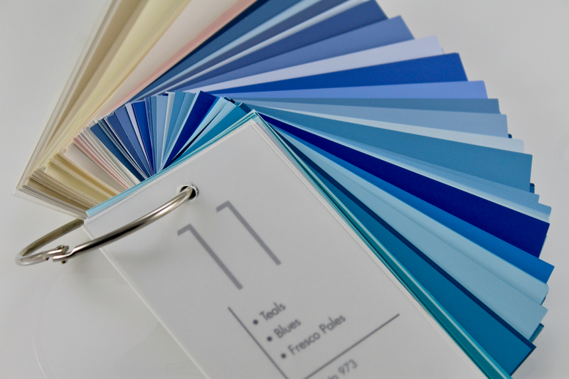 Fan of blue paint color swatches and a ring-bound sample book