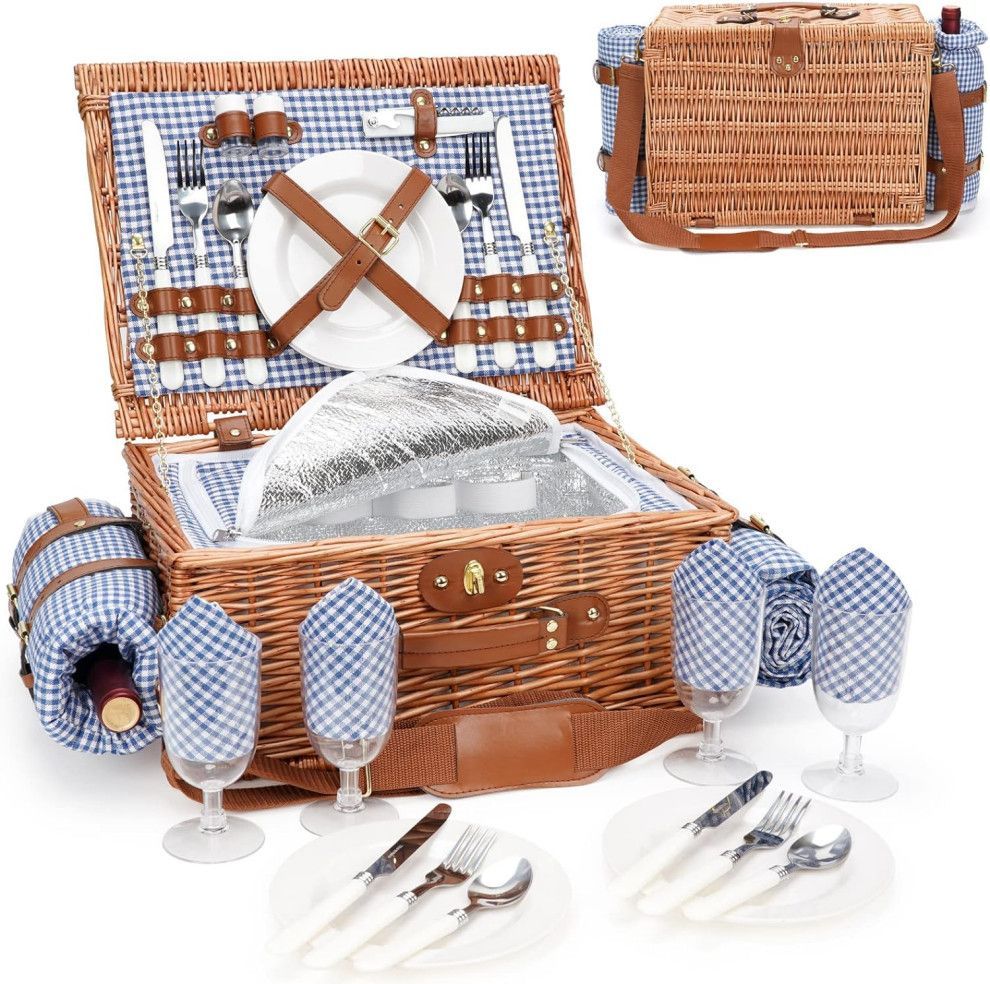 Wicker picnic basket set with blue gingham lining, plates, wine glasses, and cutlery on white background