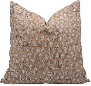 Square tan patterned decorative pillow with a subtle geometric print