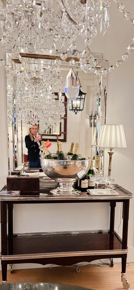Decorated console table with silver ornaments, candles, and a mirror in a bright interior