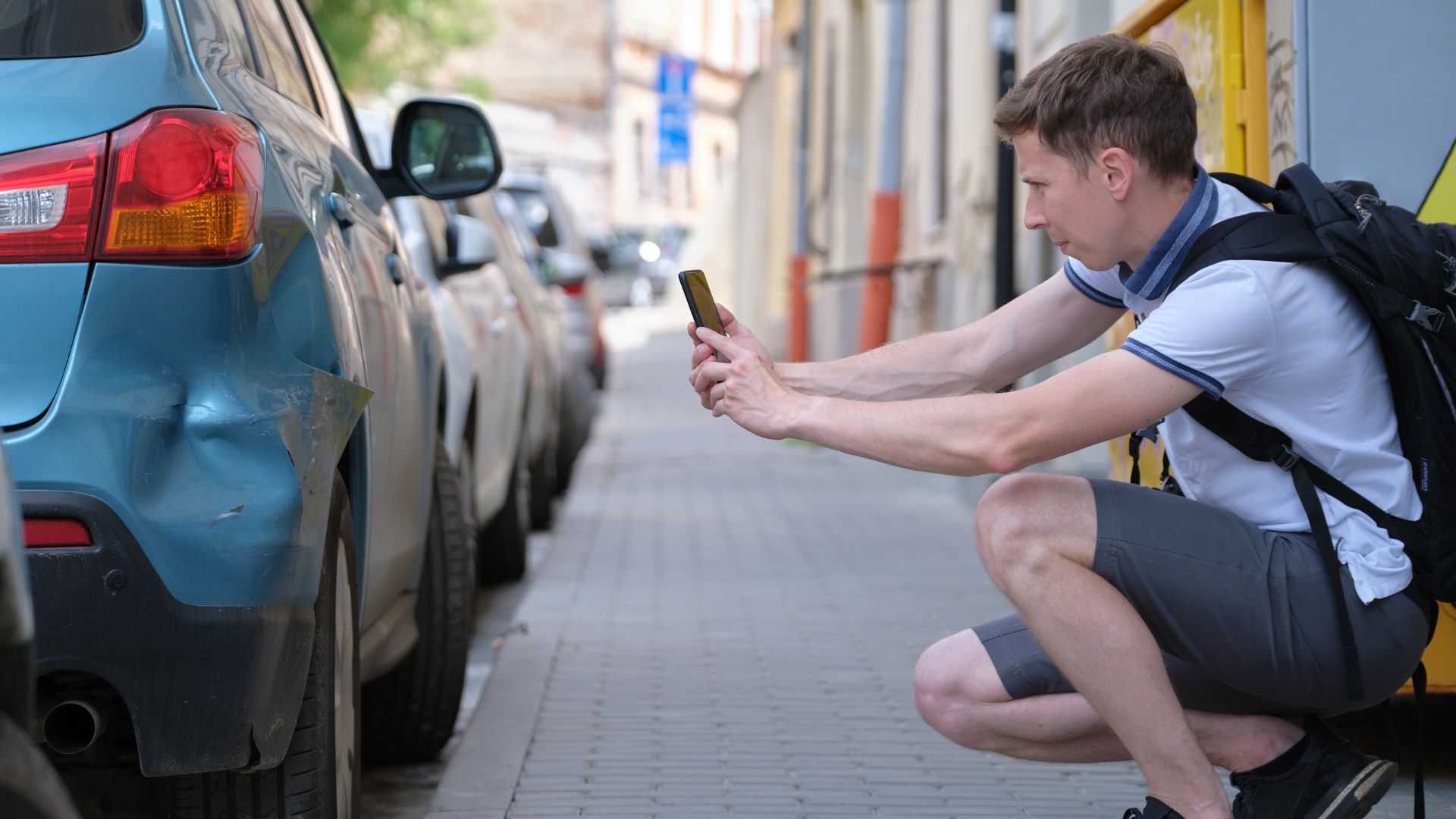 A Fender Bender and its Meaning shown by a car owner taking a photo of his car which was hit