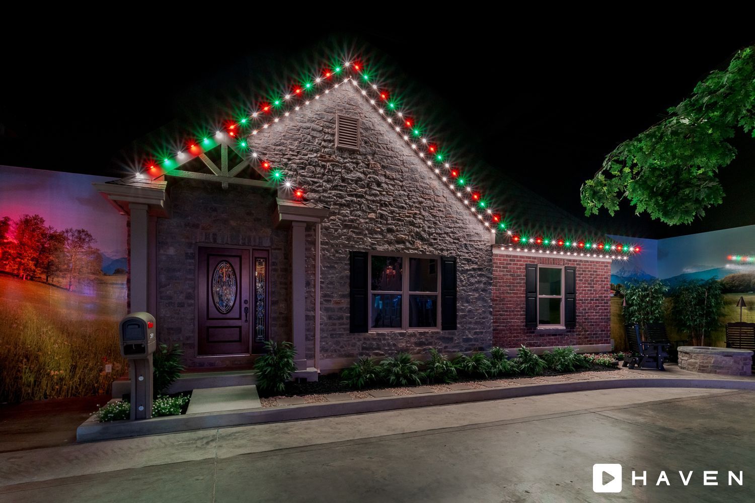A house with christmas lights on the roof is lit up at night.