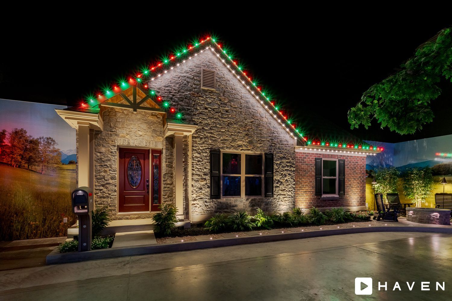 A house with christmas lights on the roof is lit up at night.
