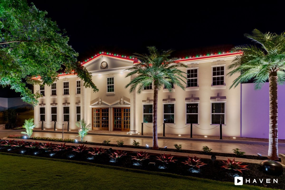 A large white building with christmas lights on it