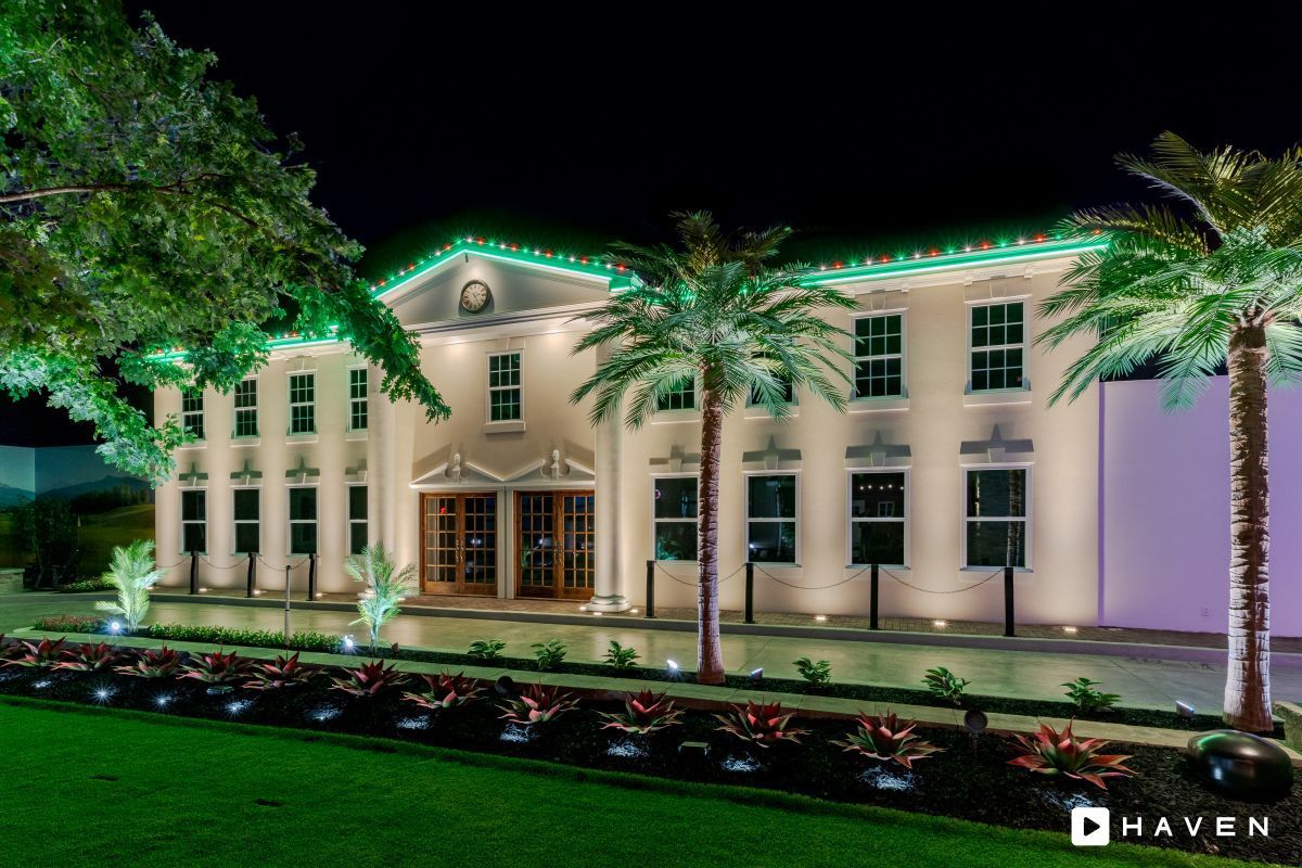 A large white building with christmas lights on it