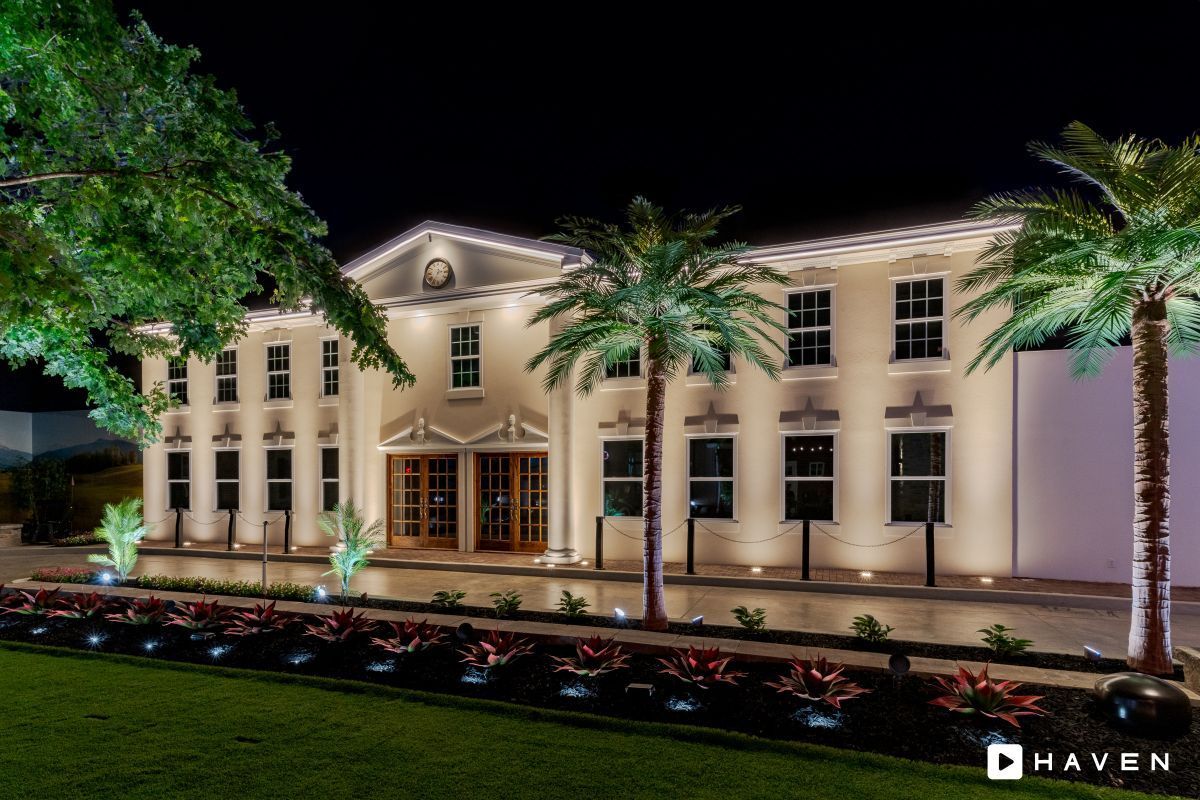 A large building with a lot of windows is lit up at night