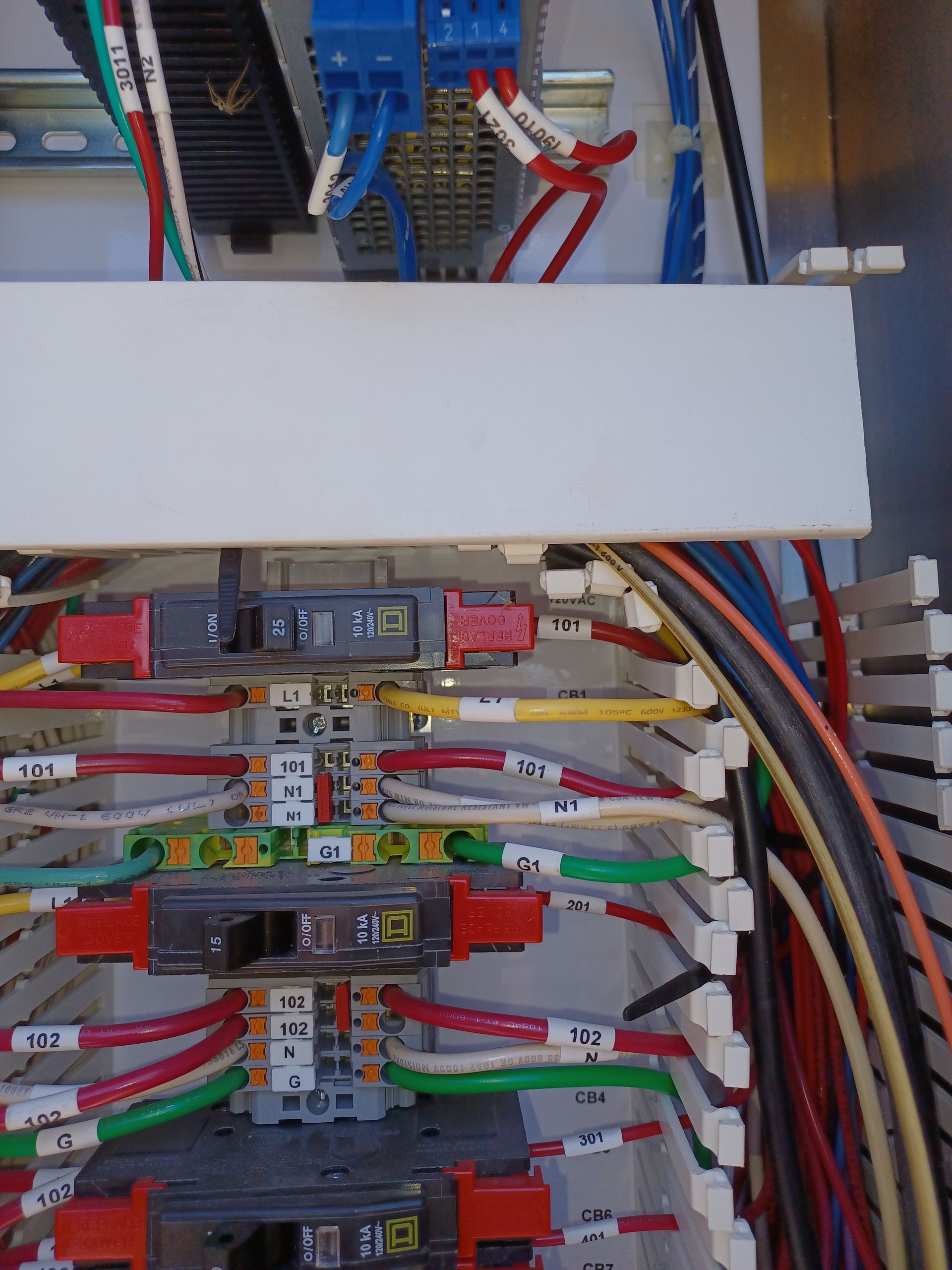 Electrical control panel with wires, terminals, and components.