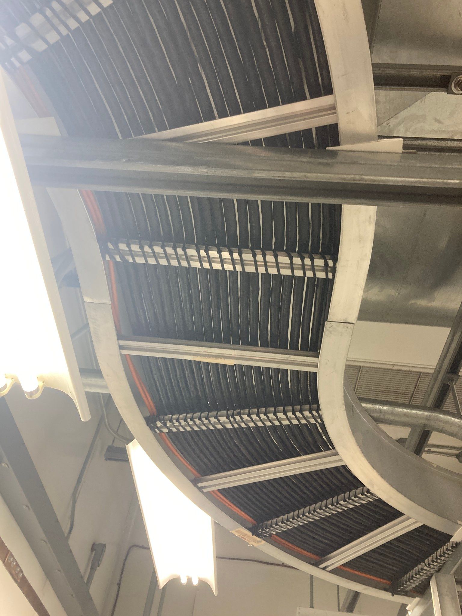 A bunch of wires are hanging from the ceiling of a building.