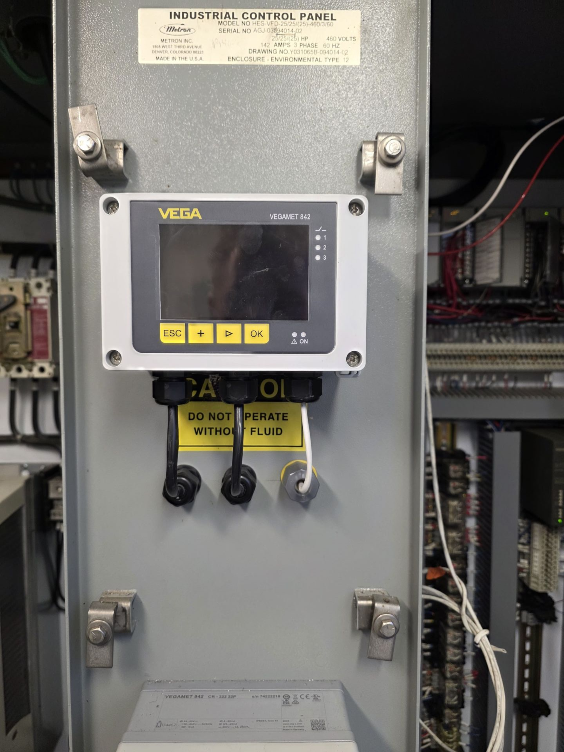 Gray electrical panel with a digital display and wiring. Labels 