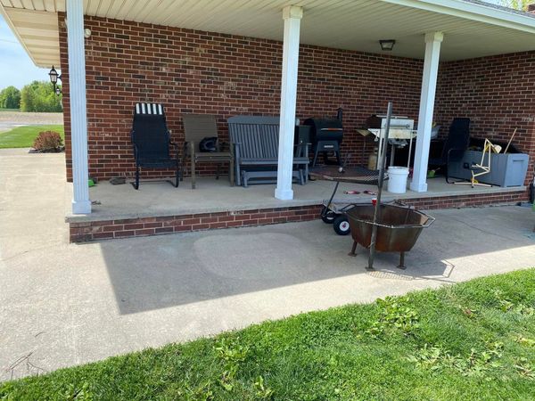 A brick house with a porch and a fire pit