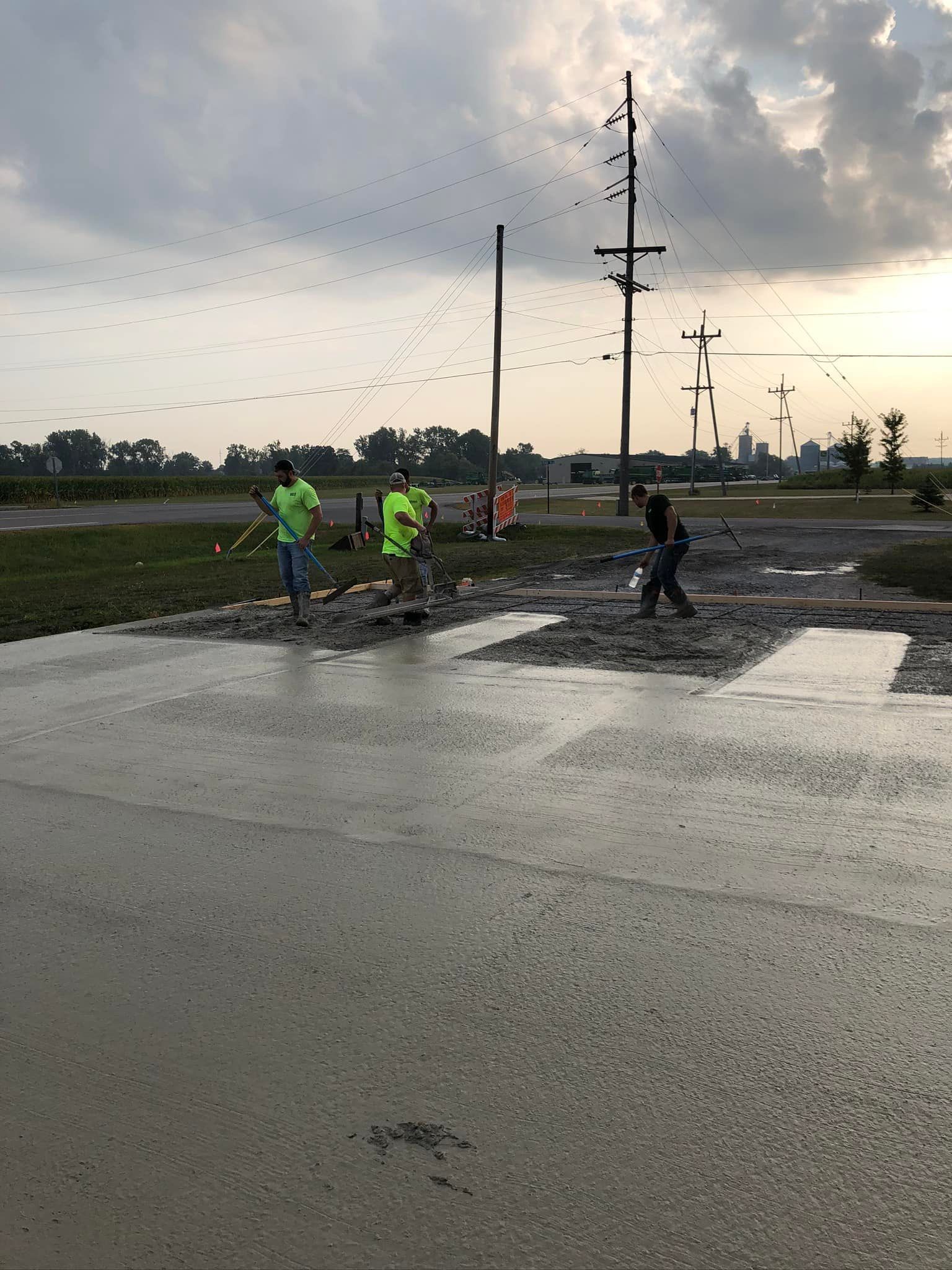 A group of people are running down a muddy road.