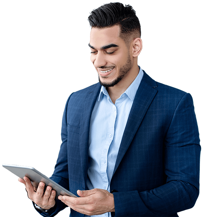 A man in a suit is holding a tablet and smiling.
