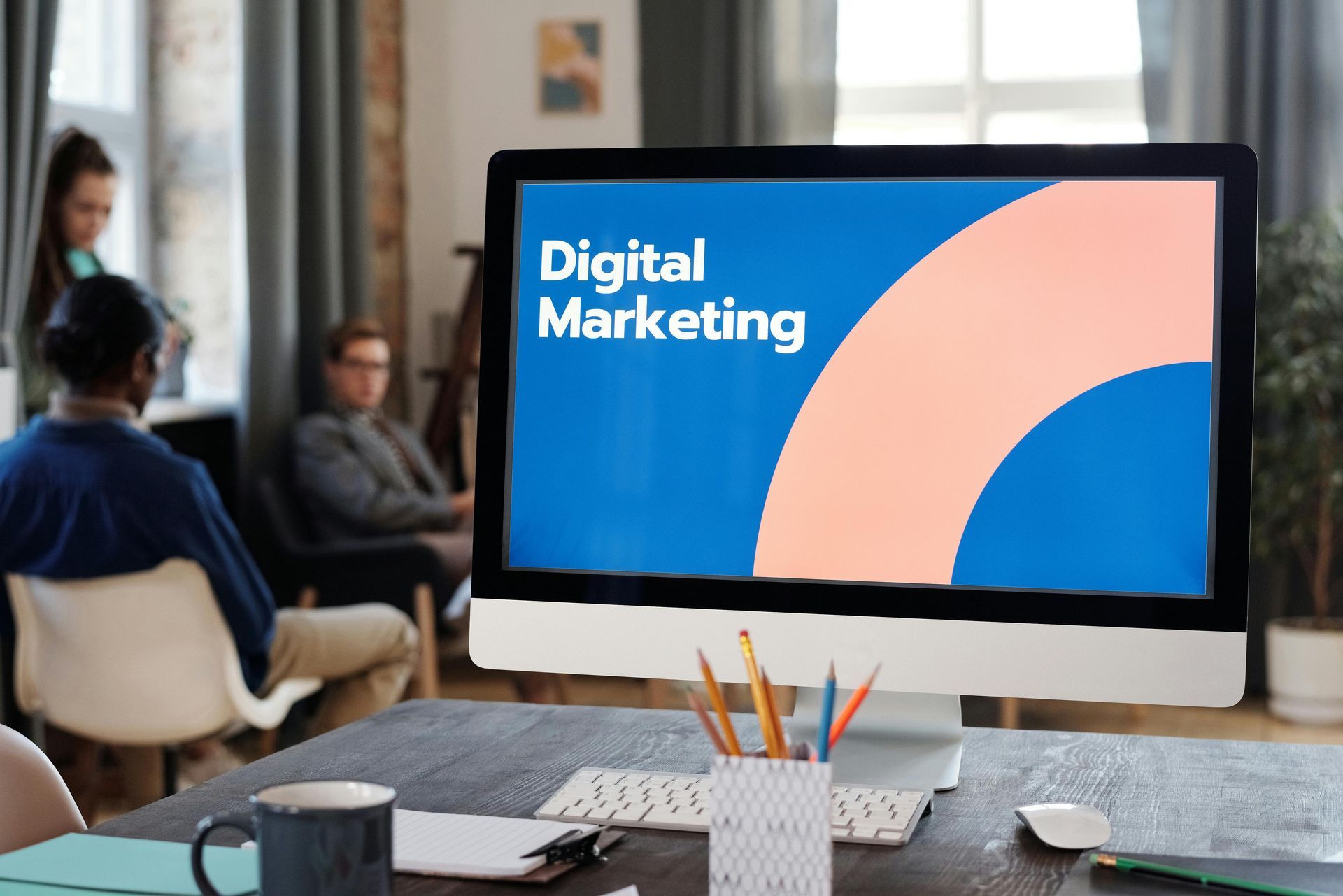 A computer monitor with the words `` digital marketing '' on it is sitting on a desk.