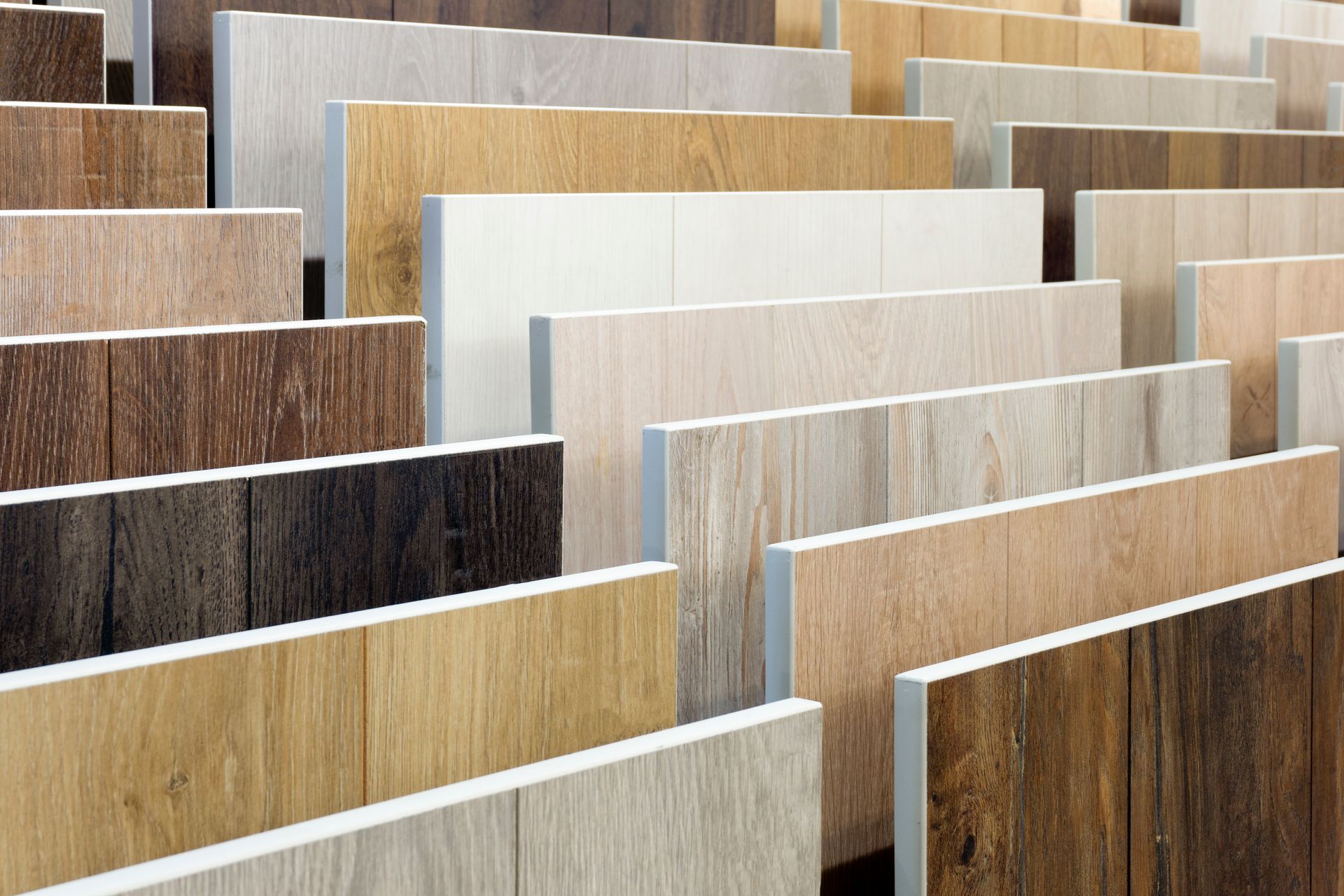 Wood-look vinyl plank samples on display at a vinyl flooring store. Wood-look vinyl plank samples on display at a vinyl flooring store.