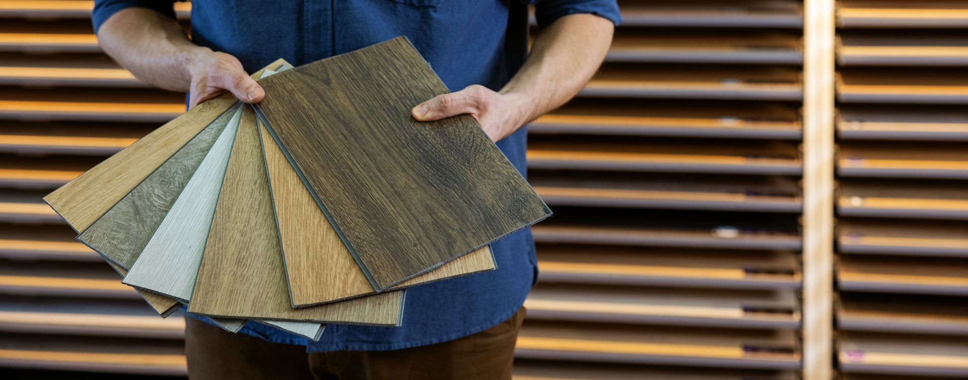Flooring store seller with vinyl floor samples in hands. Flooring store seller with vinyl floor samples in hands.