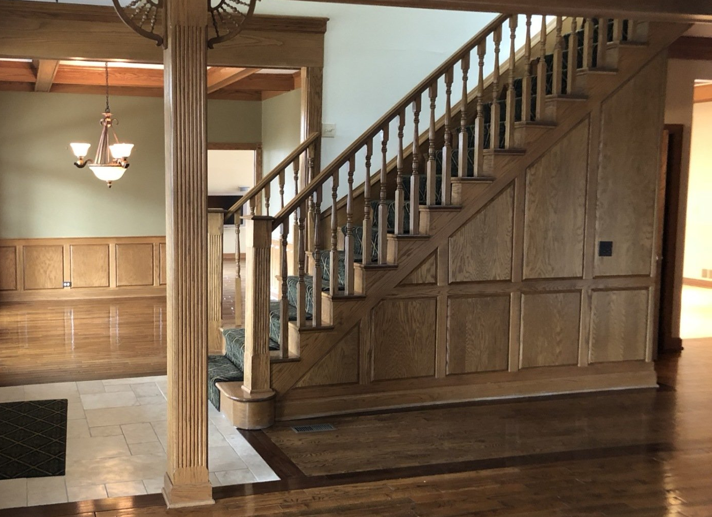 Interior with wooden staircase and paneling in an empty room