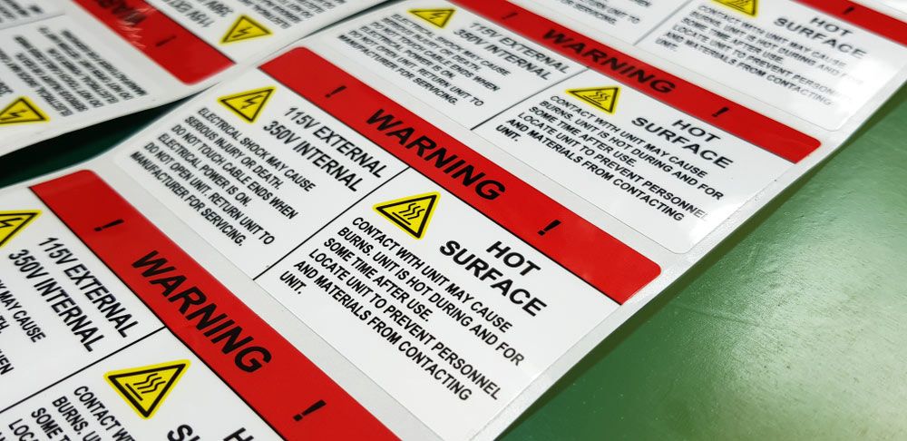A Bunch of Warning Labels That Say Hot Surface — Atherton Electrical in Atherton, QLD