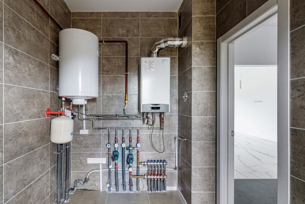 A Bathroom With a Boiler and a Water Heater — Atherton Electrical in Atherton, QLD
