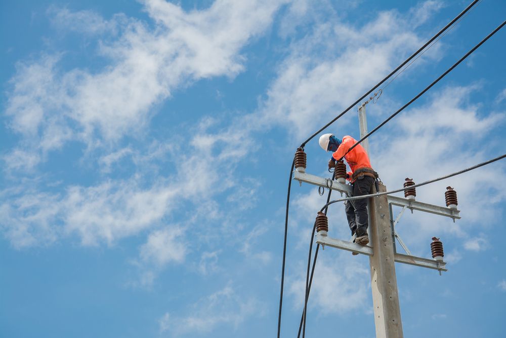 Lineman Working on Power Lines — Atherton Electrical in Mareeba, QLD