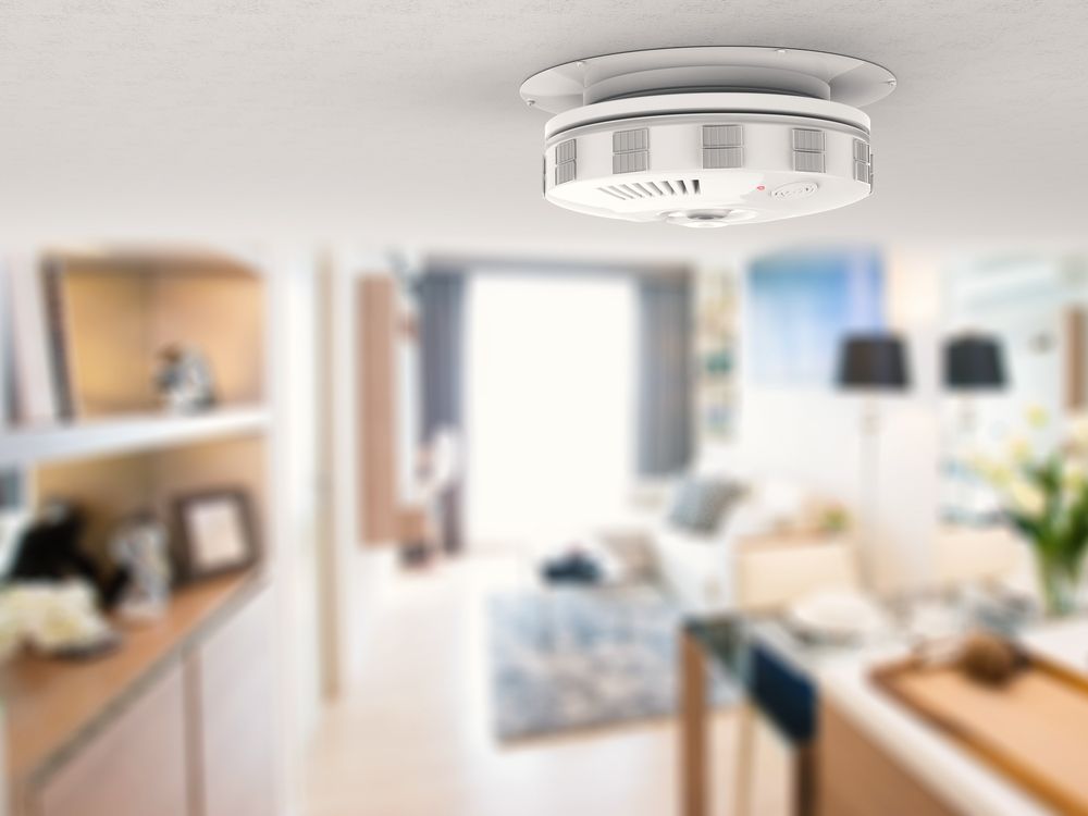 Smoke Detector Mounted on a White Ceiling in a Room — Atherton Electrical in Tolga, QLD