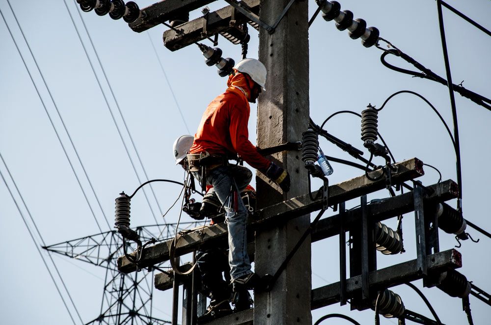 An Electrician is Working on an Electrical Pole — Atherton Electrical in Atherton, QLD