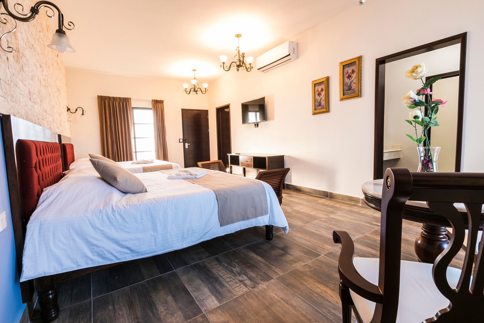 A hotel room with two beds and a ceiling fan.