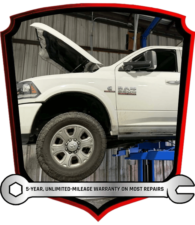 White diesel pickup truck raised on lift for inspection and repair service