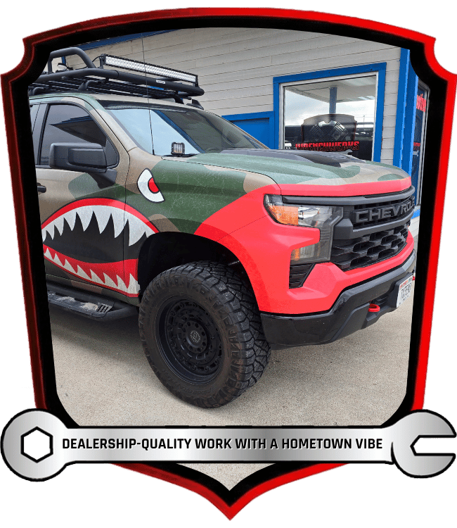 Custom Chevrolet truck with shark wrap parked outside shop