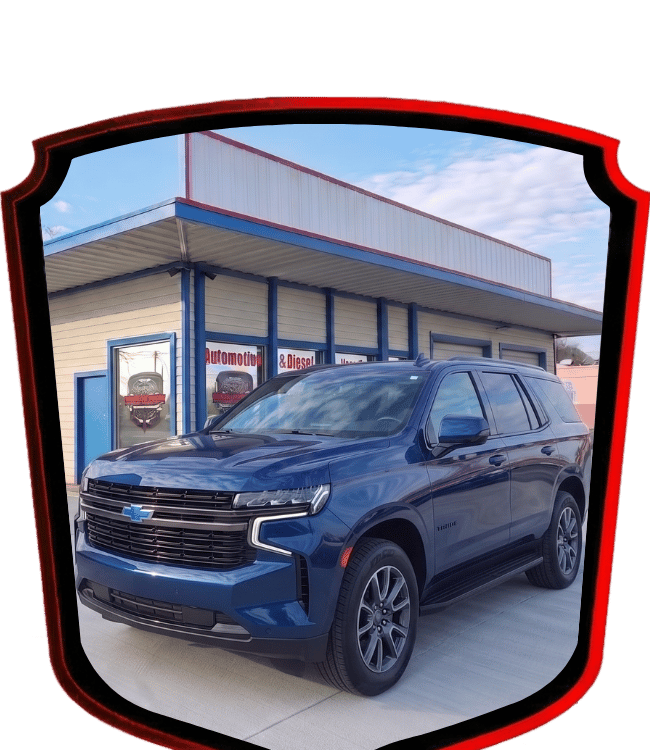 Blue Chevrolet Tahoe SUV parked outside WrenchWerks automotive repair facility