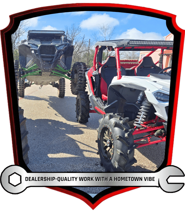 Custom lifted off-road side-by-side vehicles parked outside shop