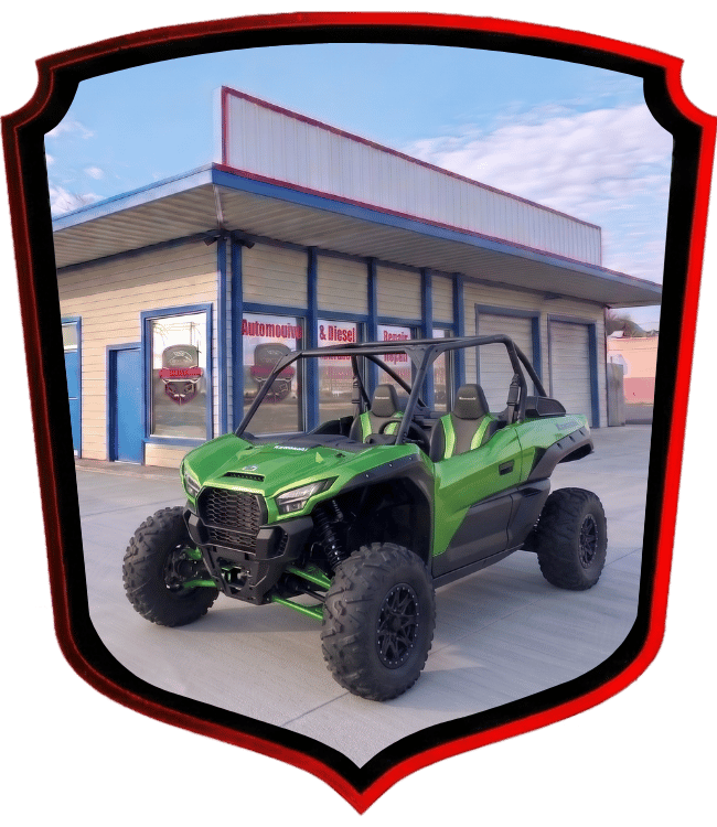 Green Kawasaki side-by-side utility vehicle parked outside WrenchWerks shop