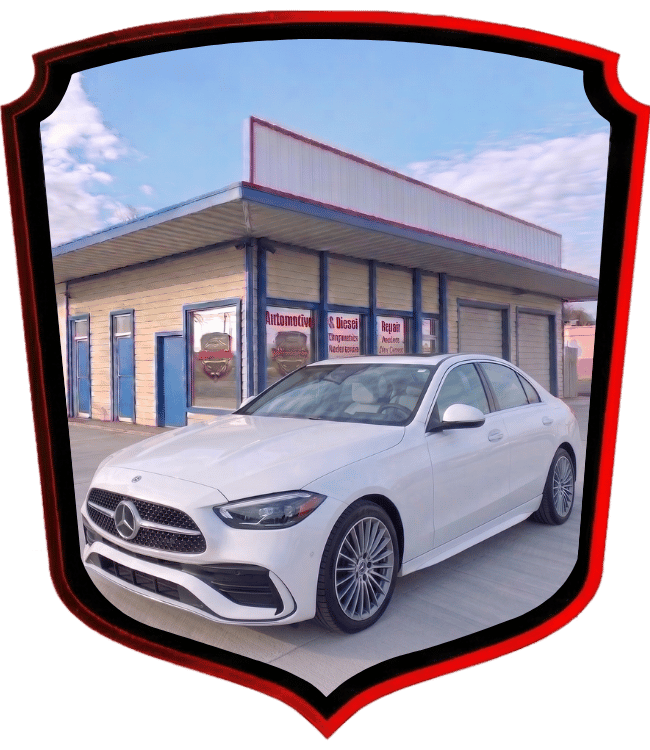 White Mercedes-Benz luxury sedan parked outside WrenchWerks shop