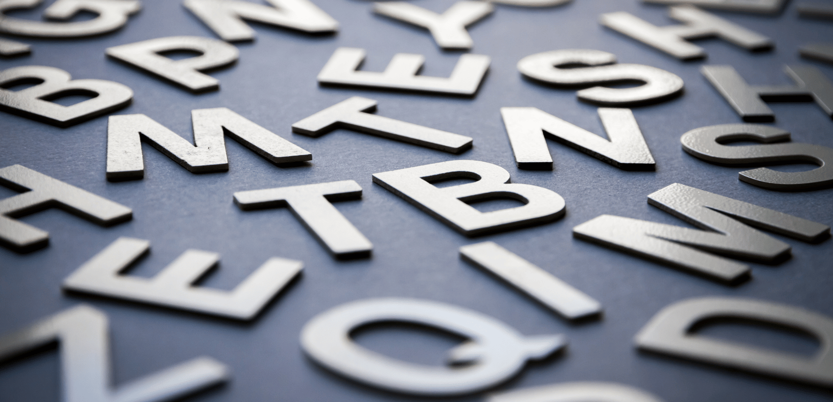 Scattered letters on a grey background