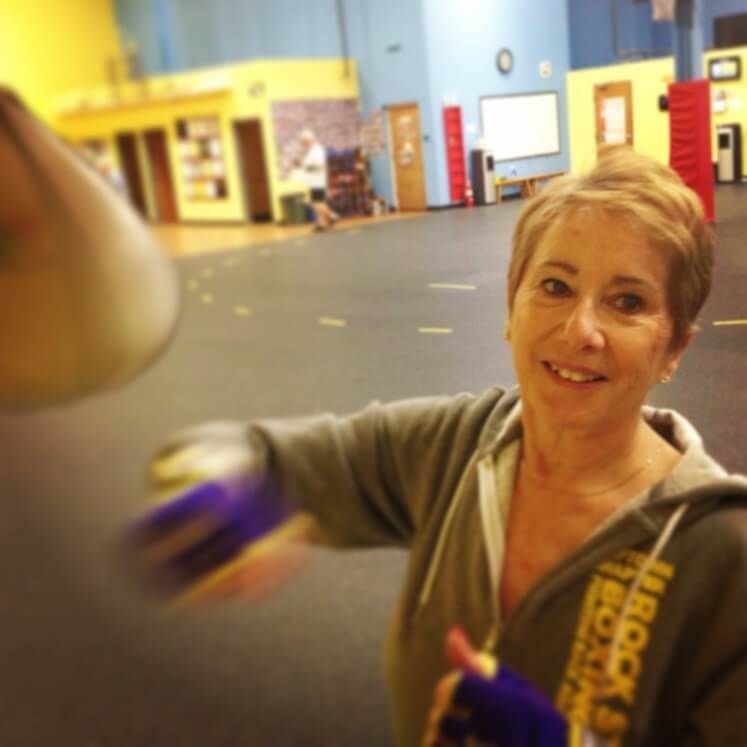 A woman wearing a hoodie that says brooklyn boxing