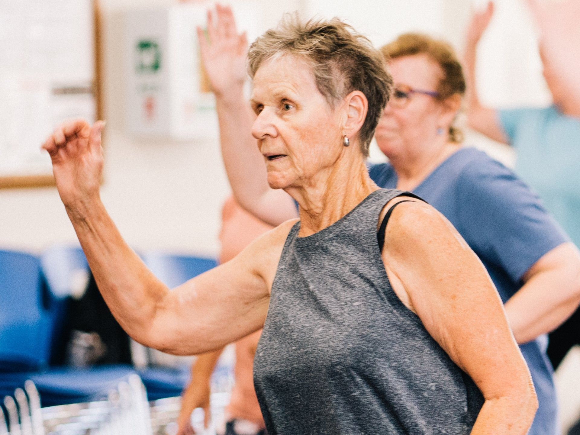 A group of older women are dancing together in a room.