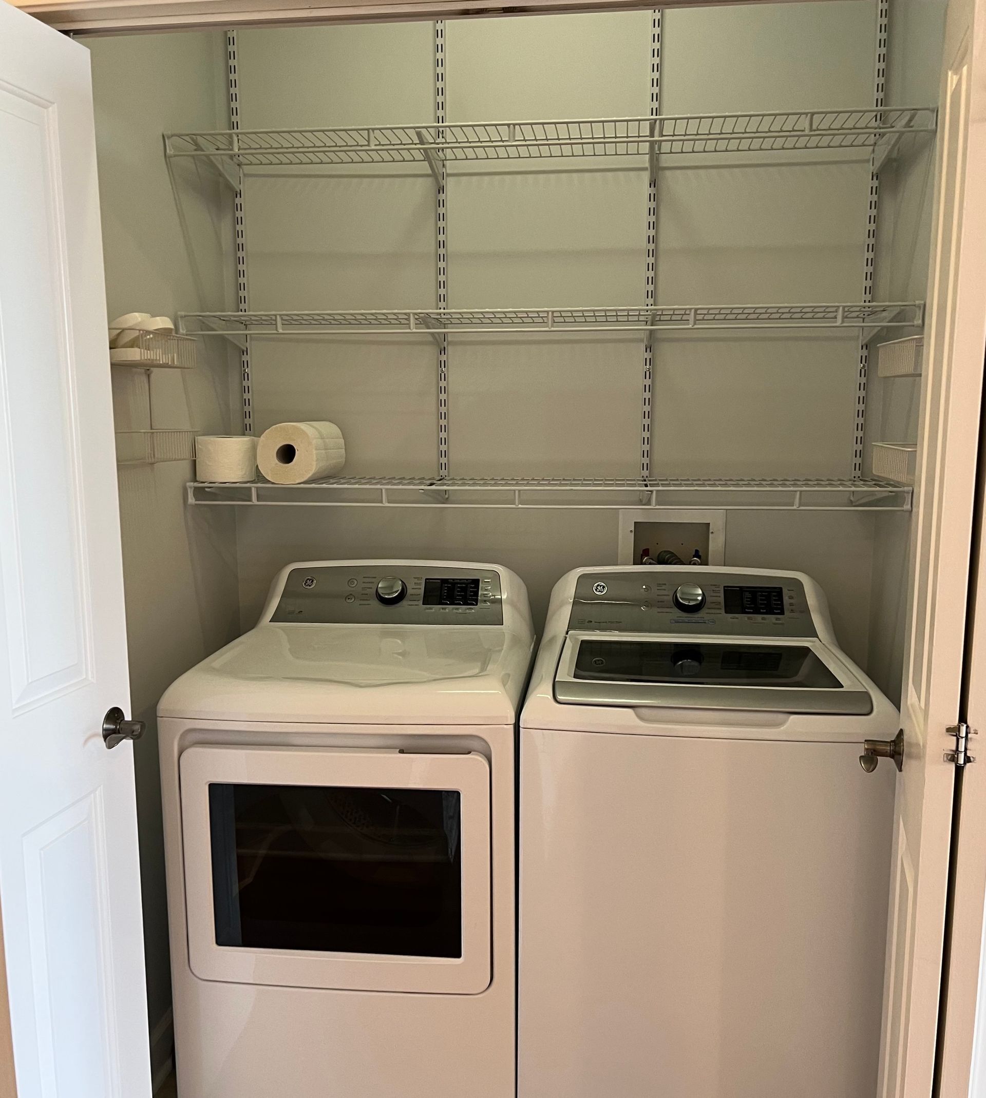 A laundry room with a washer and dryer in it