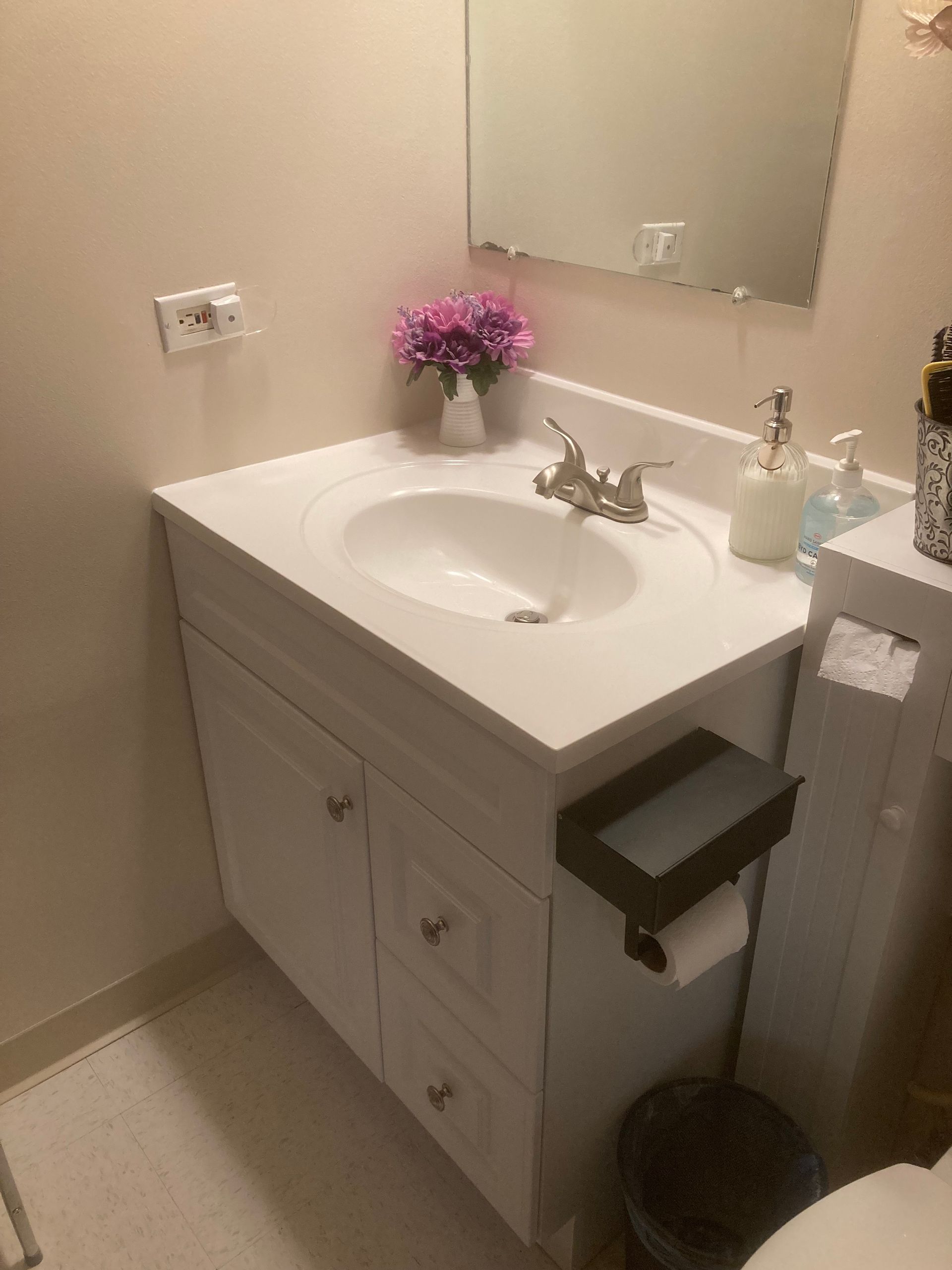 A bathroom with a sink , toilet and mirror