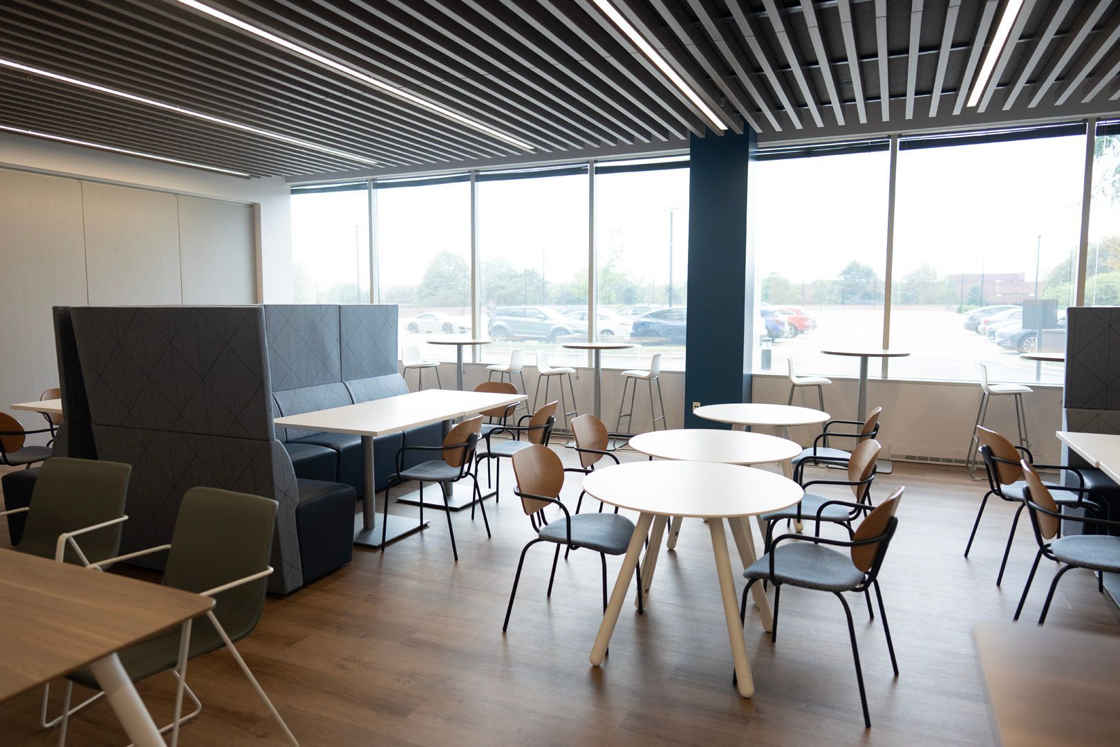 There are many tables and chairs in the room.